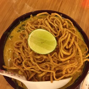 Khan Soi Gai, Northern style curry with egg noodle, chicken, shallot, pickled mustard, lime, topped with crispy noodles.
