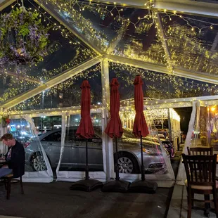 a woman sitting at a table under a tent