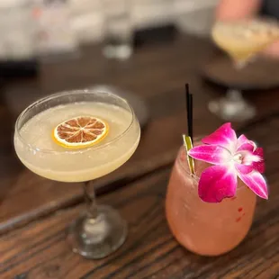 two cocktails on a wooden table