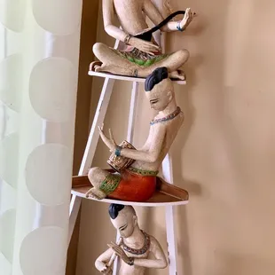 three figurines on a shelf