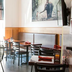 the interior of a restaurant with tables and chairs