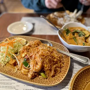 70. Pad Thai with prawns and red curry with tofu
