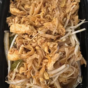 chicken and noodles in a black container