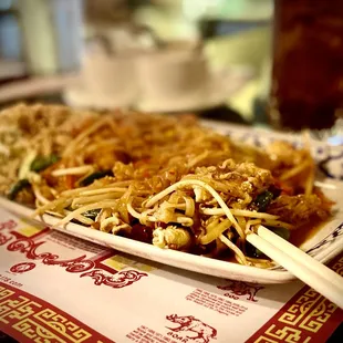 a plate of food with chopsticks