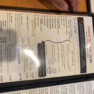 menus and a person&apos;s hand