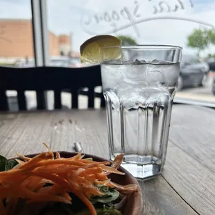 a plate of salad and a glass of water
