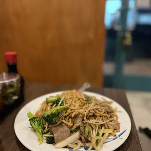 a plate of noodles with meat and vegetables