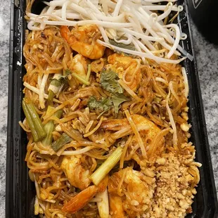 a tray of noodles and shrimp