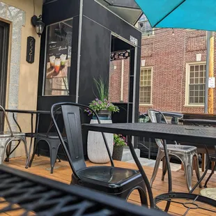 a patio with tables and chairs