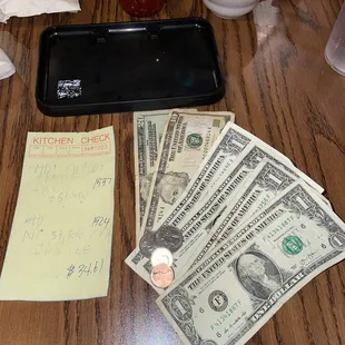 a table with money and a phone
