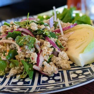 SL4. Pork Larb. $9. Spicy Thai pork salad. Ground pork, chili, roasted rice powder, onion, cilantro, scallion, Thai chili-lime dressing.