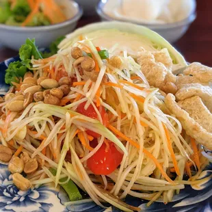 SL3. Papaya Salad. $7. Shredded papaya and carrot, string beans, tomato, peanuts, Thai chili-lime dressing, crispy pork rinds.