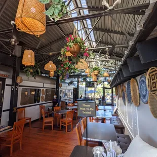 Inside the main dining room in between two train cars. Beautiful light fixtures. One of two dedicated patios out back.