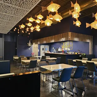 a restaurant with blue walls and tables and chairs