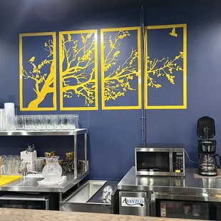 a kitchen with stainless steel counter tops and blue walls