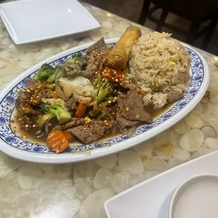 Beef and broccoli with an eggroll and fried rice