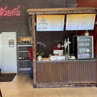 a woman standing at a counter in a restaurant