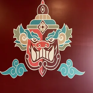 a red wall with a colorful design