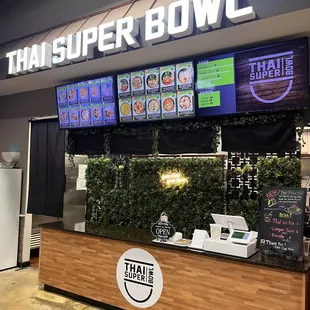 a food stand with a television screen above it