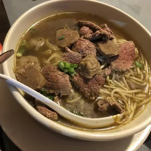 a bowl of soup with meat and noodles