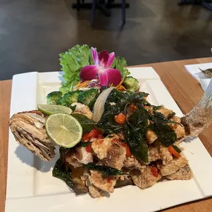 a plate of food with fish and vegetables