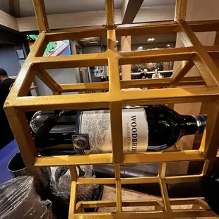 a bottle of wine in a wooden wine rack