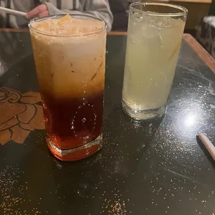 On the left is a classic Thai iced tea and the right is a ginger lemonade