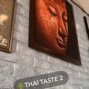 a brick wall with a buddha head on it