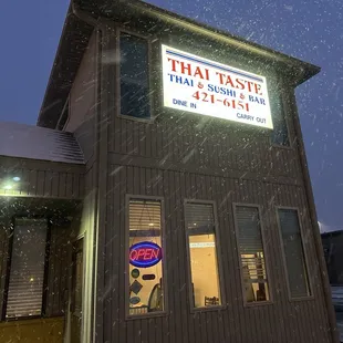 the outside of a restaurant in the snow