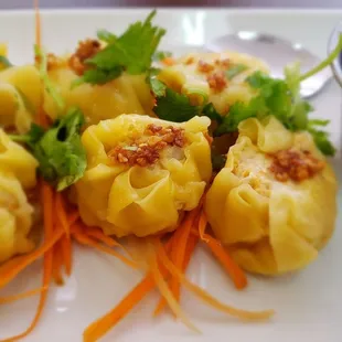 Kanom Jeeb steamed ground chicken &amp; mushroom dumplings topped with crispy ( how do they do that) garlic. I could eat my weight in these.