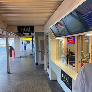 a man in a white t - shirt standing in front of a counter