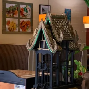 a birdcage with a roof