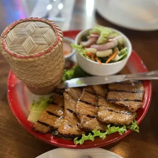 a plate of grilled meat and salad