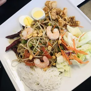 Thum Tard Hiso: papaya salad with vermicelli, shrimp, Lao jerky, boiled eggs, cabbage and pork rinds.