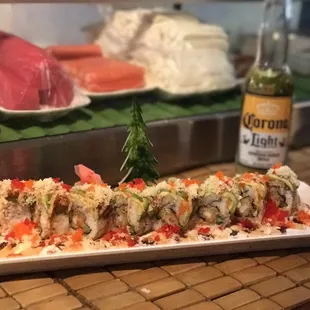 a plate of sushi and a bottle of beer