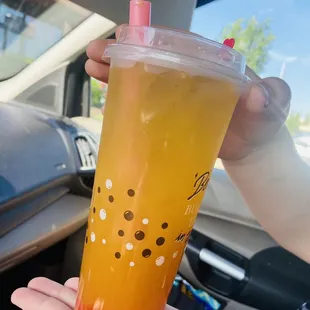 Orange tea with strawberry bubble boba