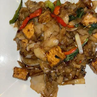 a plate of stir fried tofu and vegetables