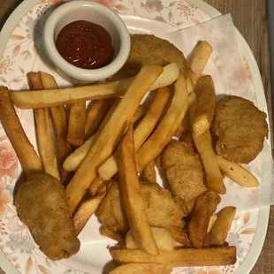 a plate of fried chicken nuggies and french fries