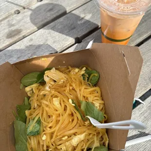 a box of noodles and a drink