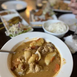 The Massaman thigh chicken curry, behind is chicken sautéed, coconut prawn, and chicken pad Thai