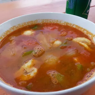 Tom Yum soup. Generous serving in ceramic bowl.