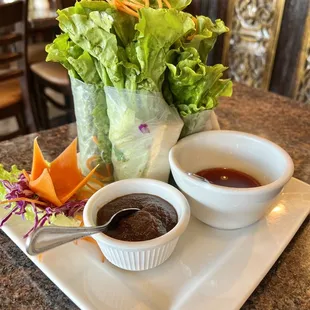 a plate of salad and dipping sauce