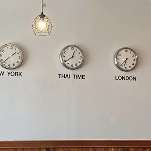 three clocks on a wall