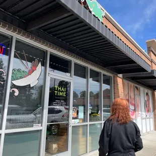a woman walking in front of a restaurant