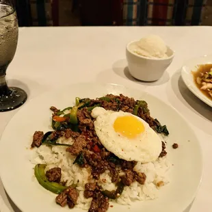 a plate of rice, meat, and an egg