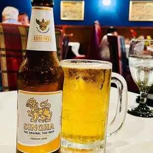 a glass of beer and a bottle of beer