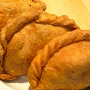 2, Curry Puff; combination of Thai pastry, stuffed, with ground chicken, potatoes, onions and curry powder.