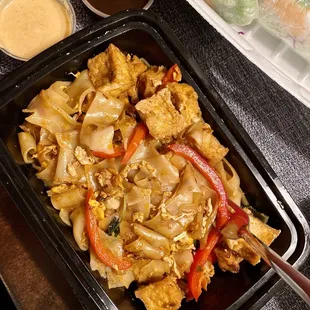 a tray of noodles and vegetables