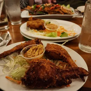 a plate of fried chicken and salad