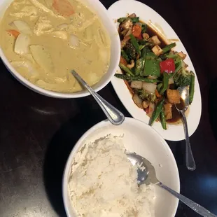two plates of food and a bowl of rice